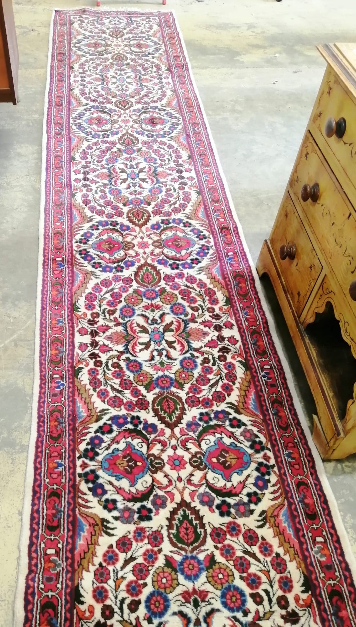 A Persian cream ground runner with central foliate motifs, 400 x 86cm